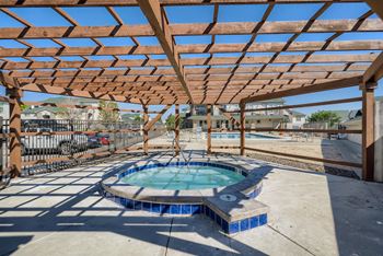 A wooden pergola shades a spa hot tub at Fox Run Lofts Apartments, Englewood CO